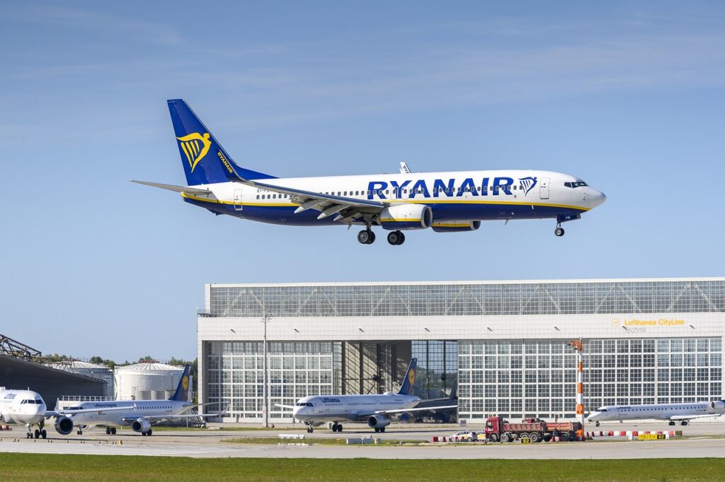 Ryanair plane flying. Are you really getting a good deal when you see the price? Consider the extras