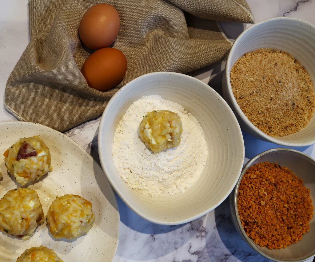 assembling the arancini with eggs, flour and breadcrumbs