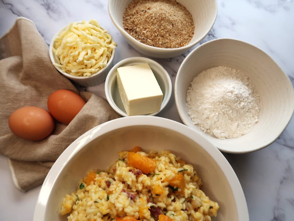 ingredients required for arancini, risotto, flour, eggs, cheeses and breadcrumbs