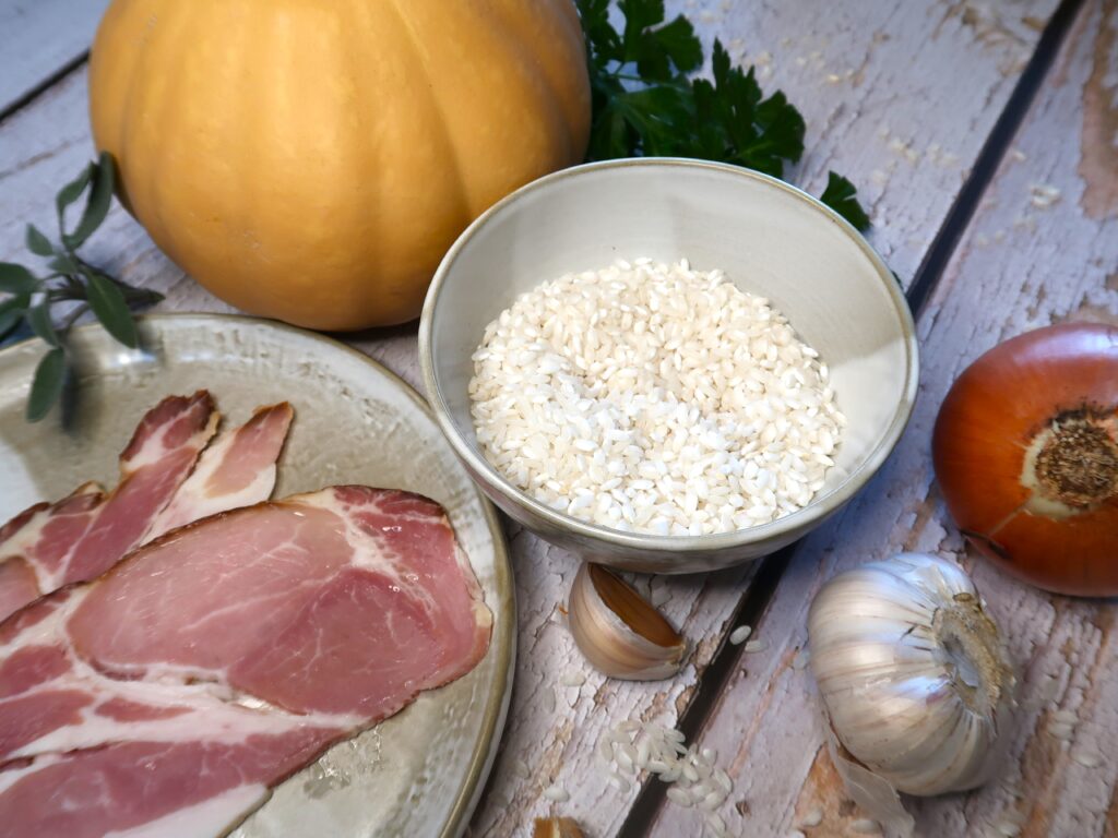 ingredients used for this bacon pumpkin risotto, arborio rice, onion, garlic, bacon and pumpkin