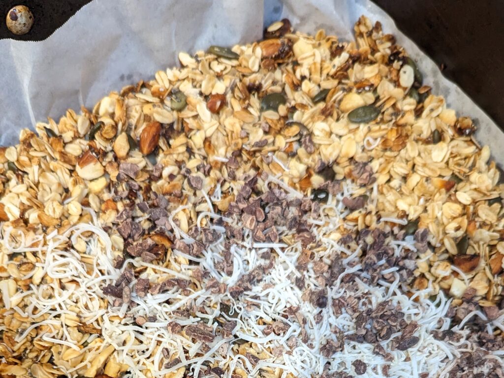 Homemade nut granola with coconut and cacao nibs added towards the end of cooking